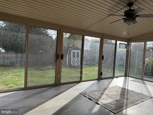 a porch with a table and chairs