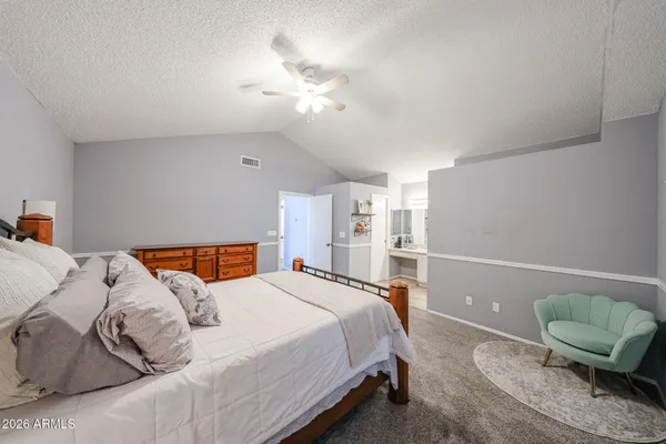 a bedroom with a bed and chandelier