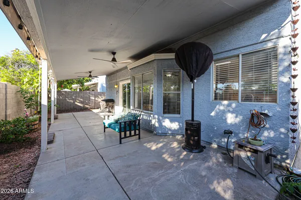 a view of living room with patio furniture and potted plants