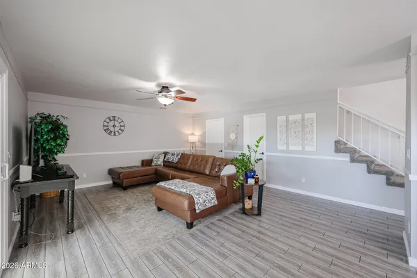a living room with furniture and wooden floor