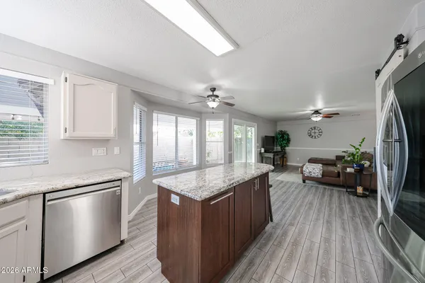 a kitchen with sink cabinets and wooden floor