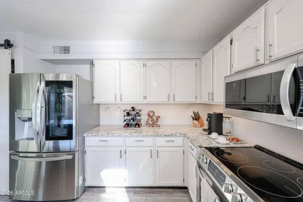 a kitchen with a sink and stainless steel appliances