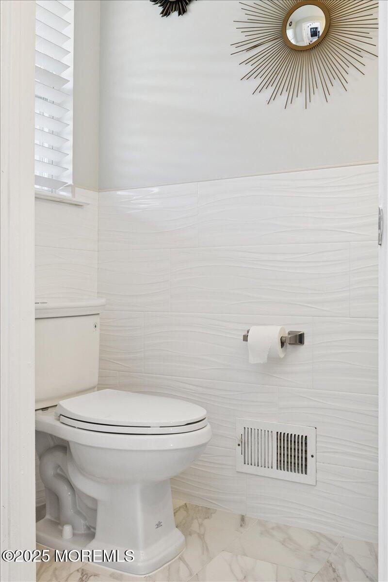 2 Higgins Court Howell, NJ 07731 - Photo 22 of 49 a bathroom with a toilet and a shower