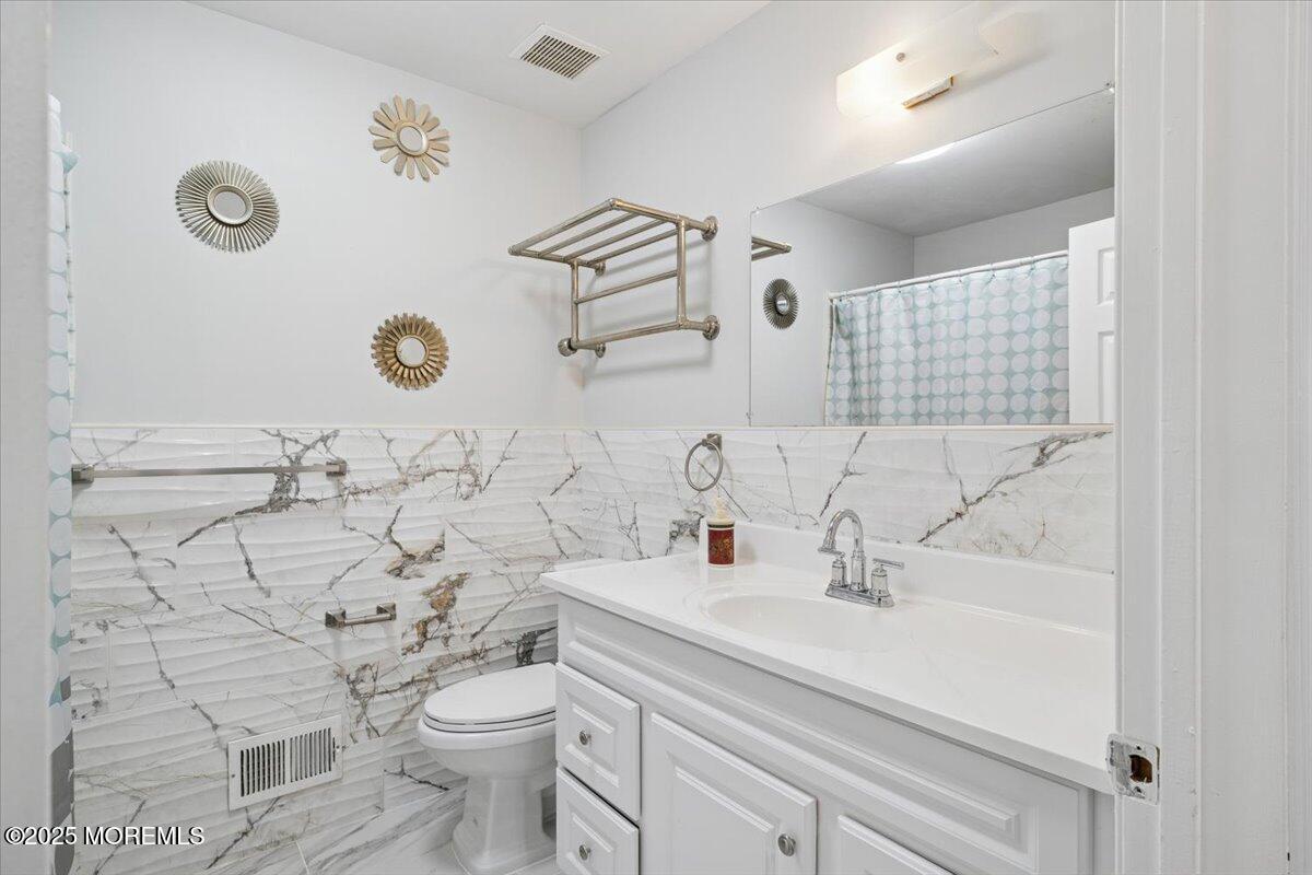 2 Higgins Court Howell, NJ 07731 - Photo 33 of 49 a bathroom with a sink mirror and toilet