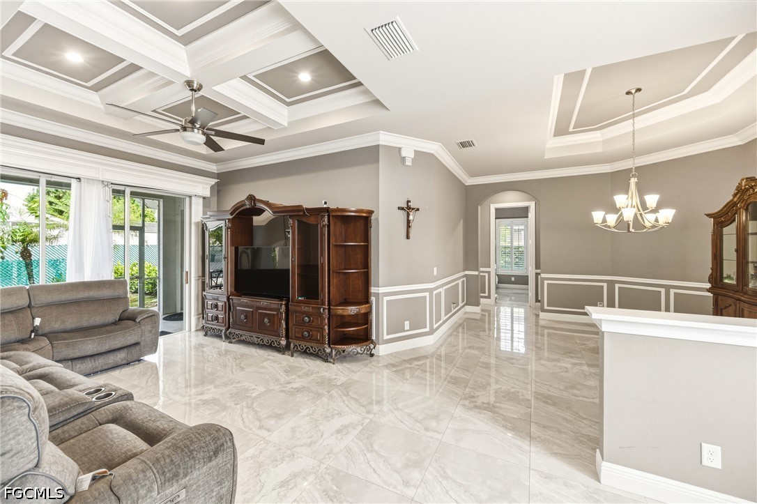1700 43rd Terrace Southwest Naples, FL 34116 - Photo 32 of 38 a living room with furniture and a flat screen tv