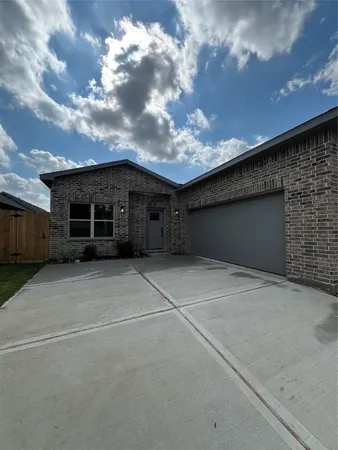 a view of a car garage with a bench