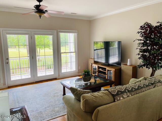581 River Ridge Road, Unit 4 Shallotte, NC 28470 - Photo 4 of 50 Looking out into the oversized living room, which shows off the great views of the golf course