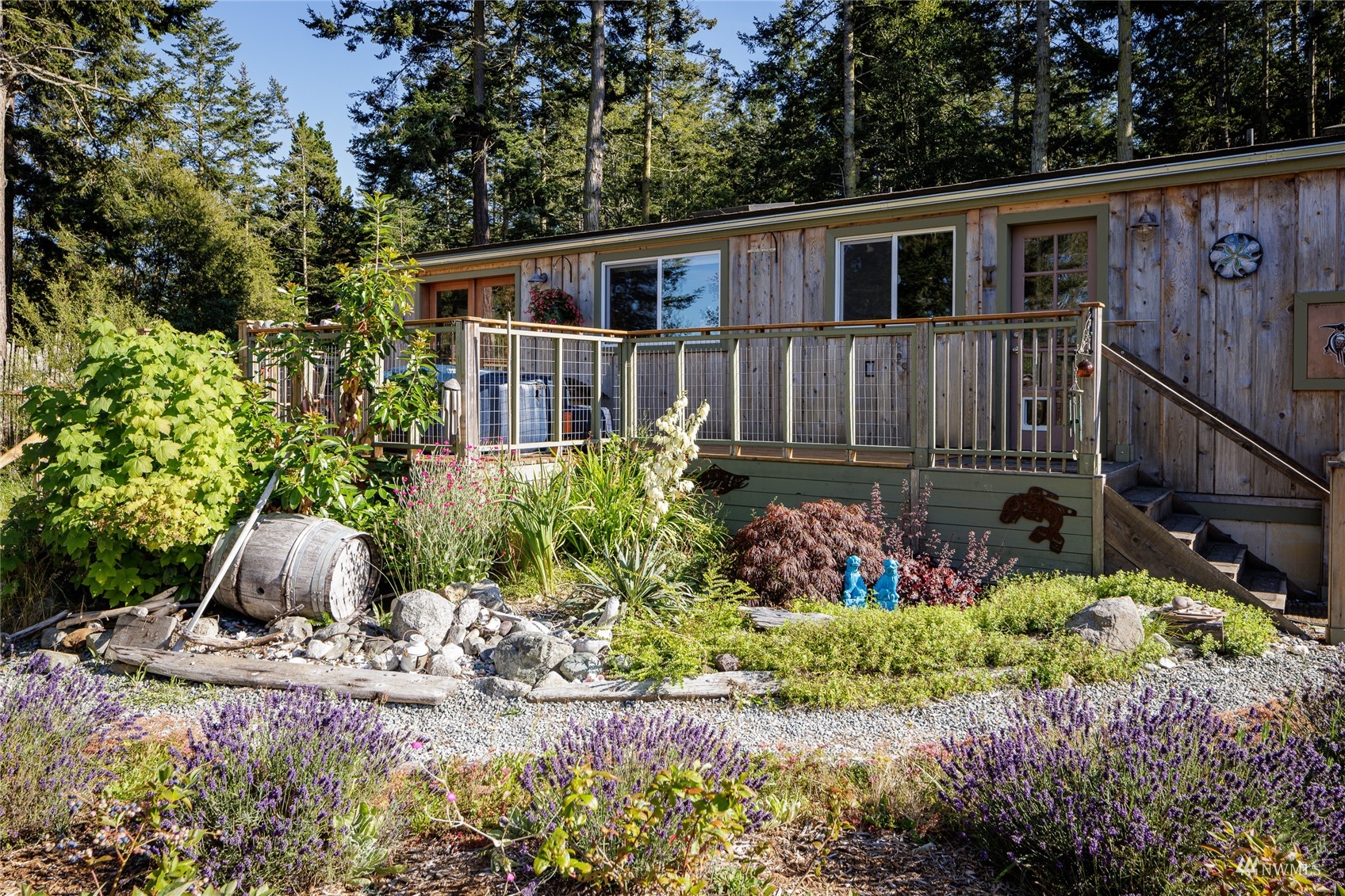 268 Wren Road Lopez Island, WA 98261 - Photo 1 of 23 a view of a house with wooden floor and flower plants