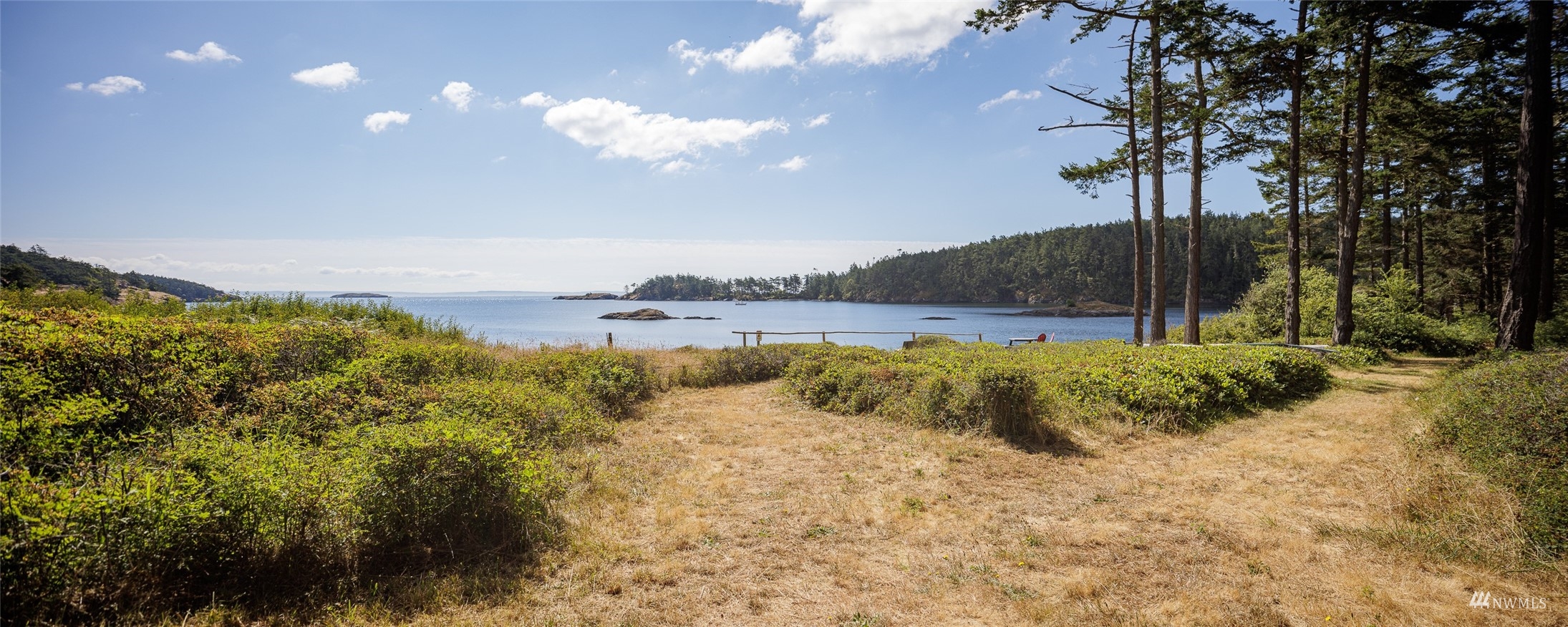 268 Wren Road Lopez Island, WA 98261 - Photo 23 of 23 a view of a lake with a yard and trees