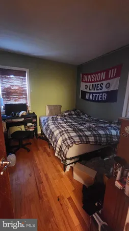 a living room with a bed and a flat screen tv