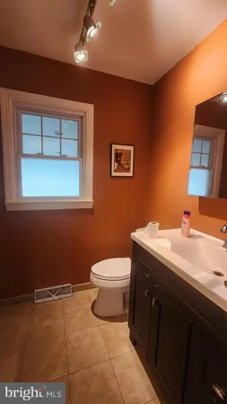 a bathroom with a sink a toilet and mirror