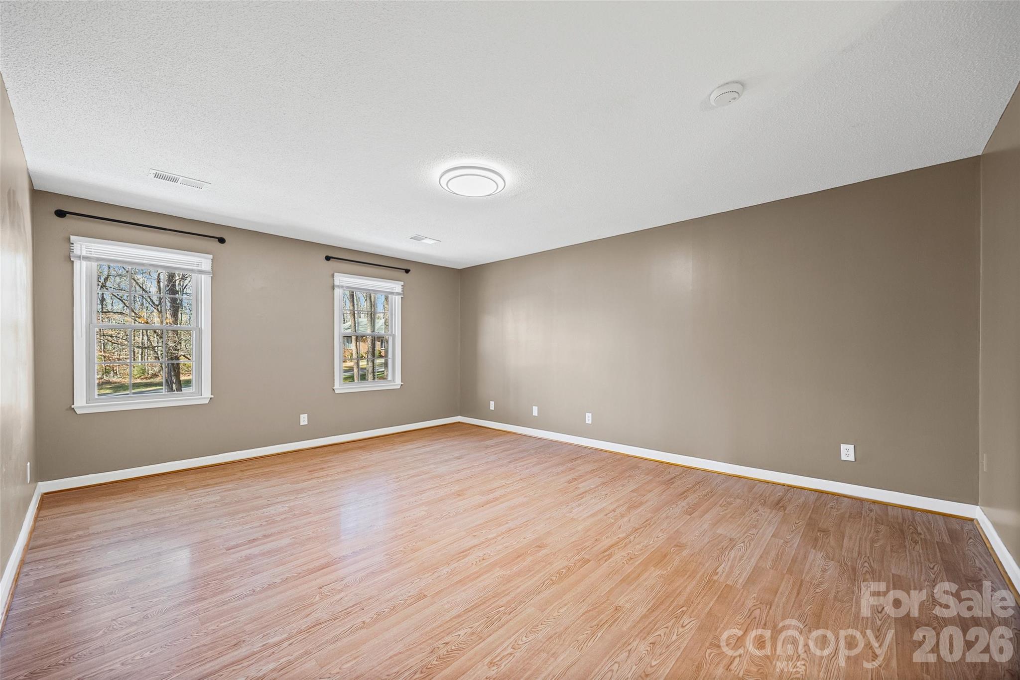 405 Bratton Avenue York, SC 29745 - Photo 20 of 43 a view of an empty room with wooden floor and a window