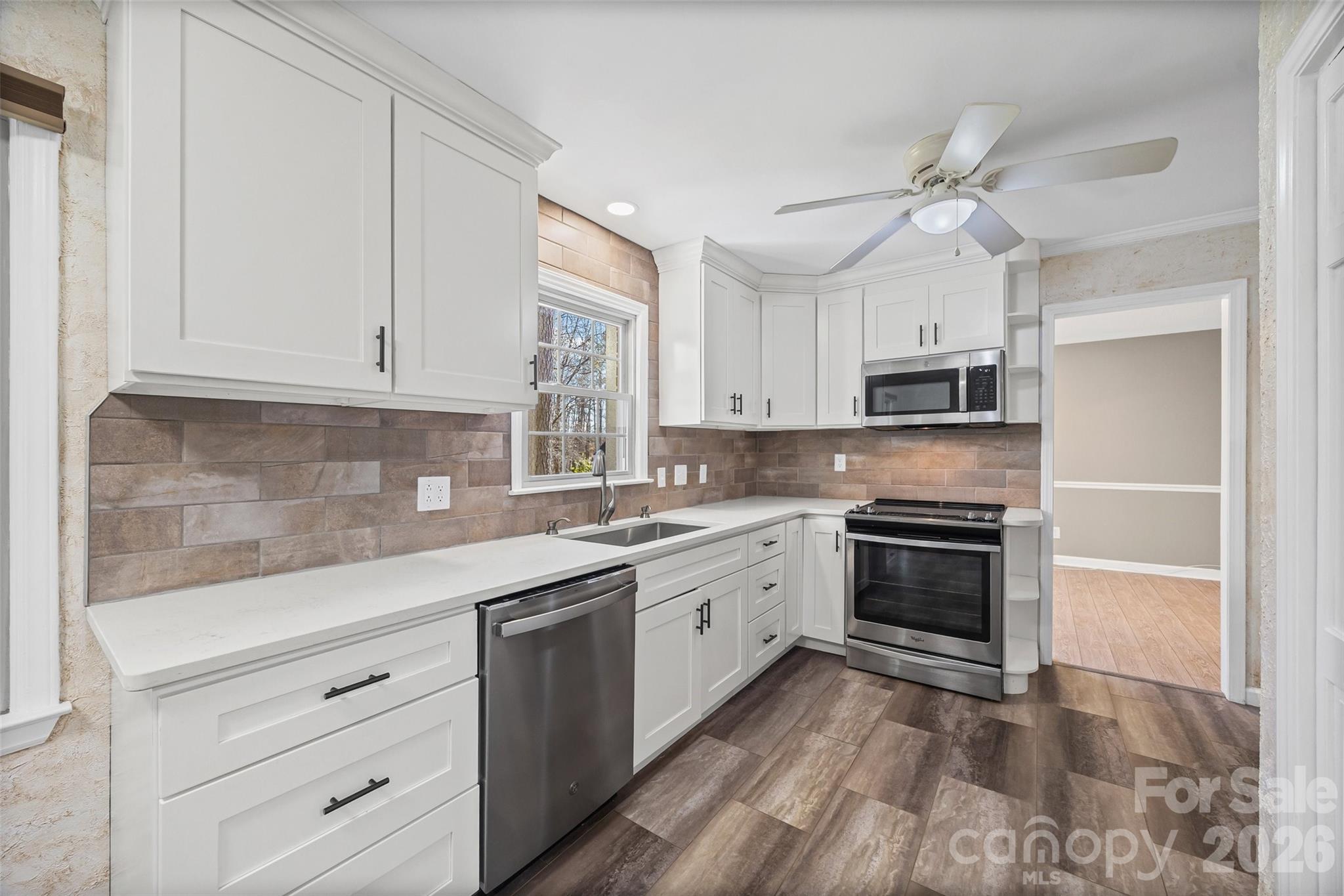 405 Bratton Avenue York, SC 29745 - Photo 10 of 43 a kitchen with stainless steel appliances granite countertop a stove sink and refrigerator