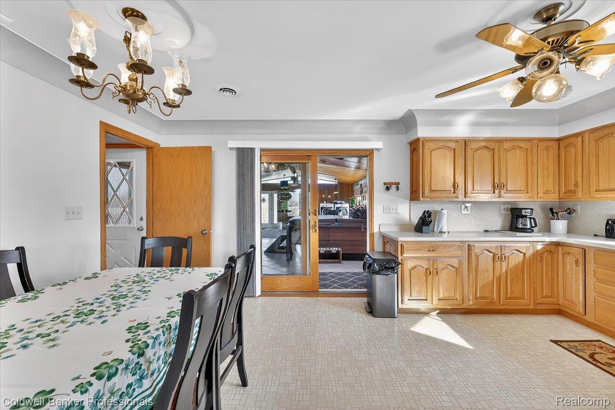 7410 Wilson Road Montrose, MI 48457 - Photo 15 of 38 Kitchen with light countertops, hanging lights, a ceiling fan, light floors, and wood finish cabinetry