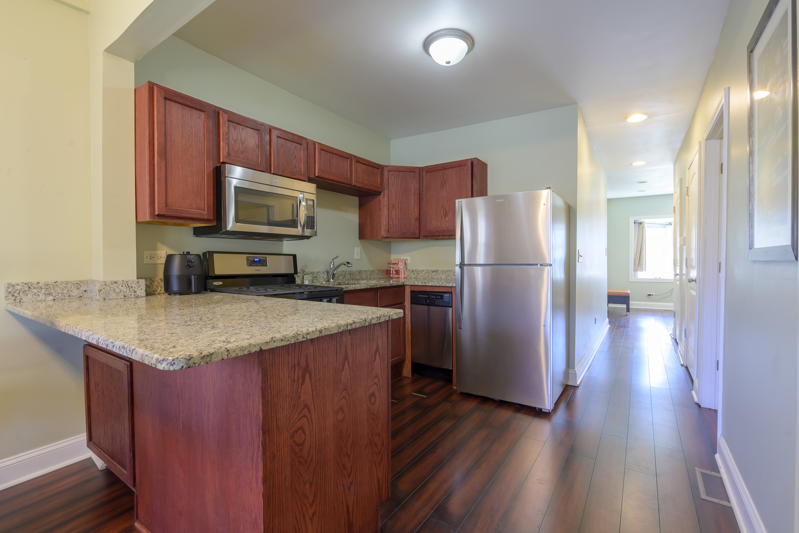 2436 West Fillmore Street Chicago, IL 60612 - Photo 14 of 44 a kitchen with stainless steel appliances granite countertop a refrigerator microwave and stove