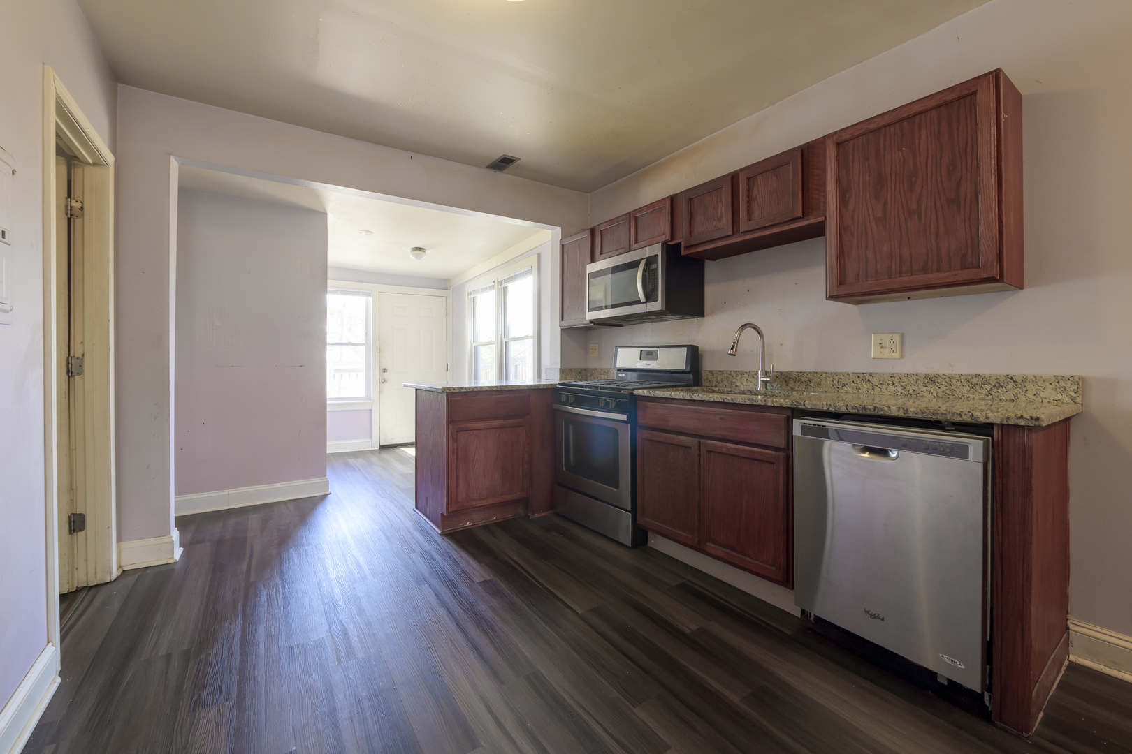 2436 West Fillmore Street Chicago, IL 60612 - Photo 25 of 44 a kitchen with granite countertop a sink cabinets and wooden floor