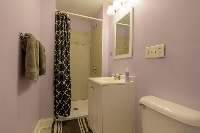 a bathroom with a shower toilet and sink