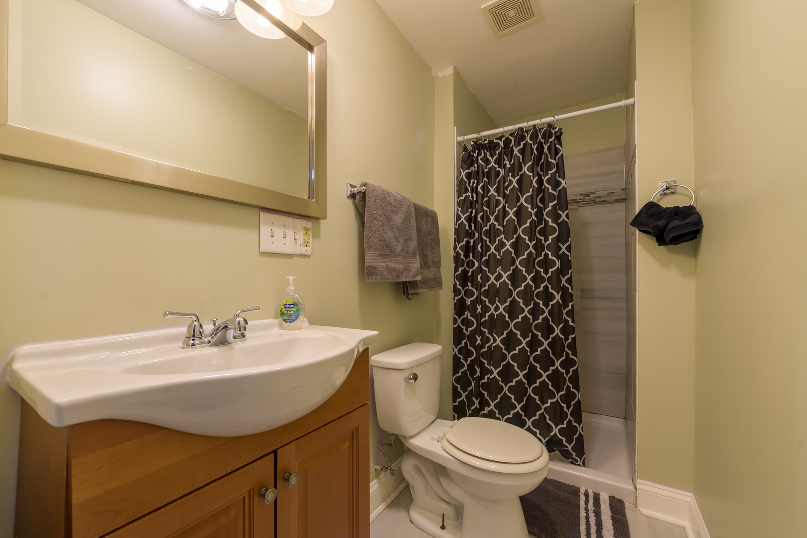2436 West Fillmore Street Chicago, IL 60612 - Photo 9 of 44 a bathroom with a sink a toilet and a mirror