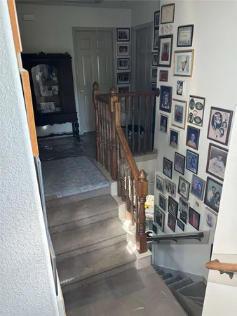 a view of staircase with white walls and a window