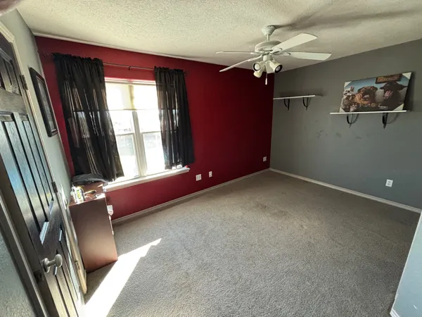 a view of living room with furniture and a floor to ceiling window
