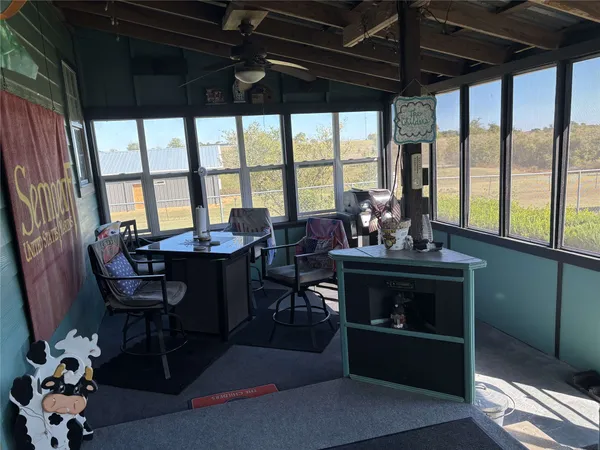 a living room with furniture a window and gym equipment