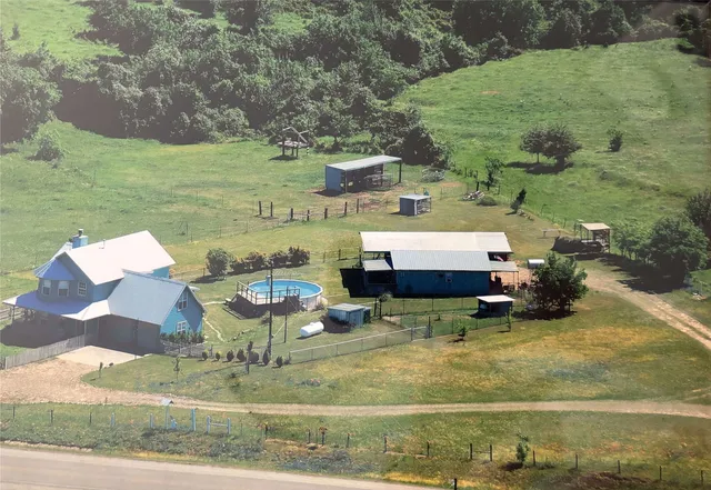 a backyard of a house with table and chairs