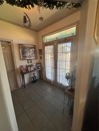 a bedroom with furniture and large window