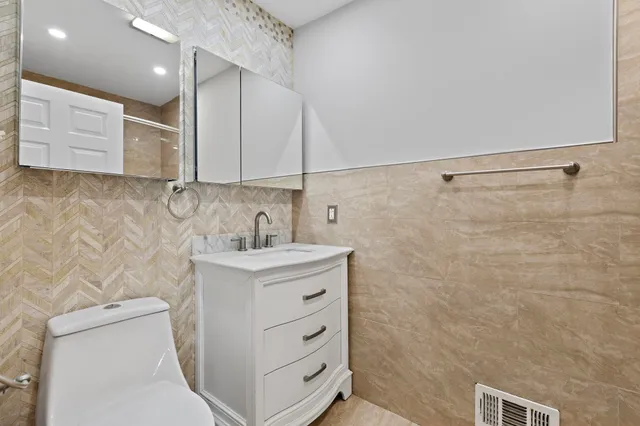 a bathroom with a sink a toilet and a shower