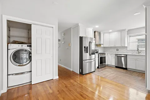a kitchen with a refrigerator a washer and dryer