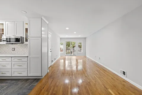 a view of lot of kitchen and wooden floor