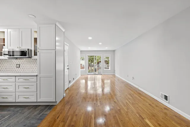 a view of lot of kitchen and wooden floor