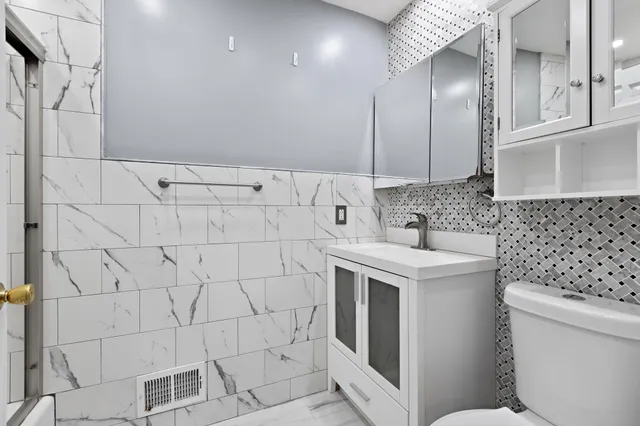 a bathroom with a sink toilet and shower