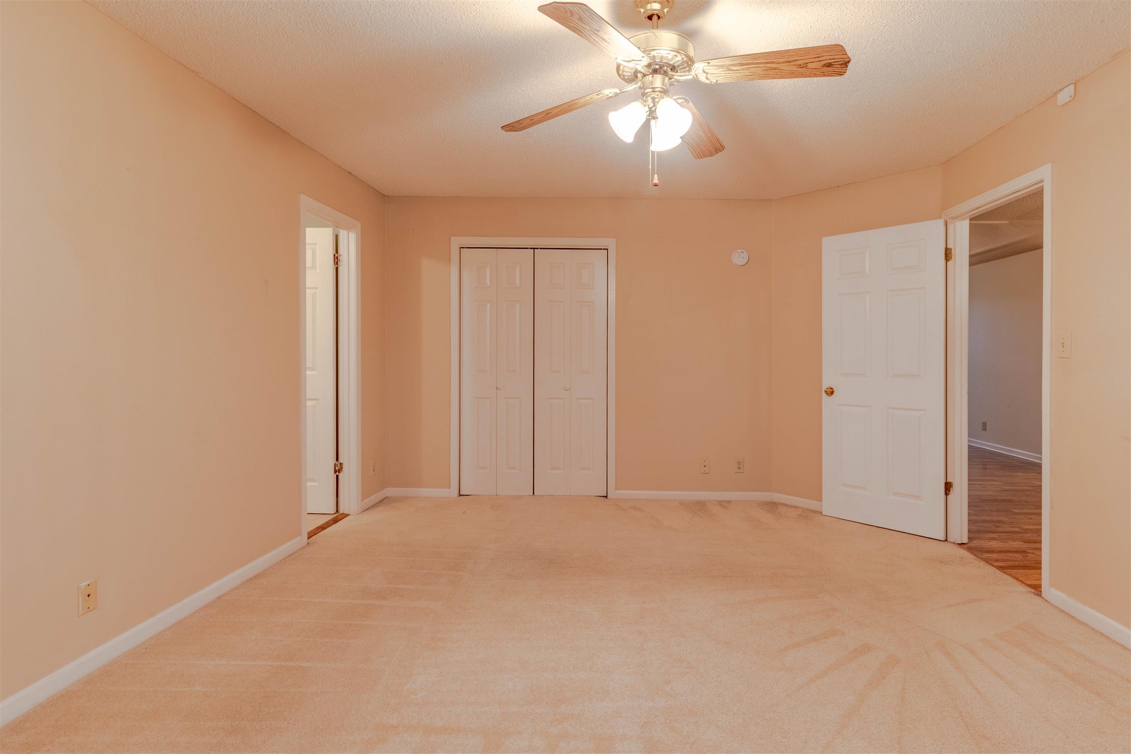 3411 Polly Drive Clarksville, TN 37042 - Photo 11 of 20 an empty room with closet and a chandelier fan