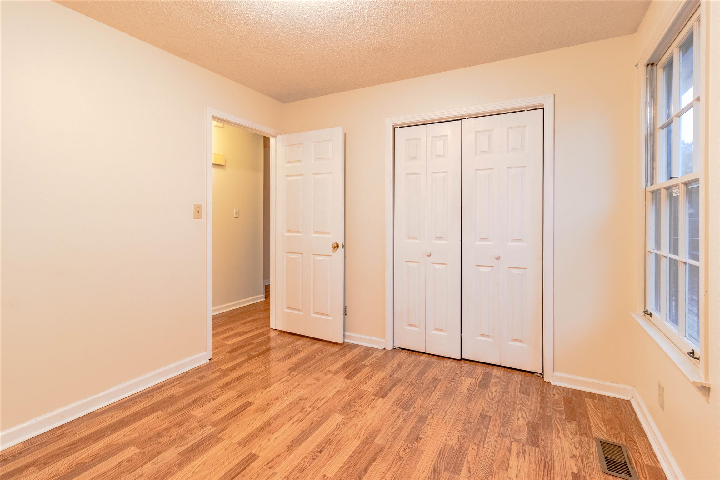 3411 Polly Drive Clarksville, TN 37042 - Photo 14 of 20 an empty room with wooden floor and a window