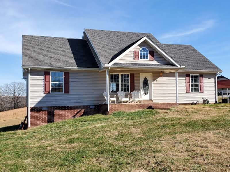 573 Womack Road Bethpage, TN 37022 - Photo 1 of 21 a front view of a house with a garden and porch
