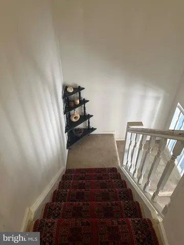 a bedroom with a bed dresser and a window