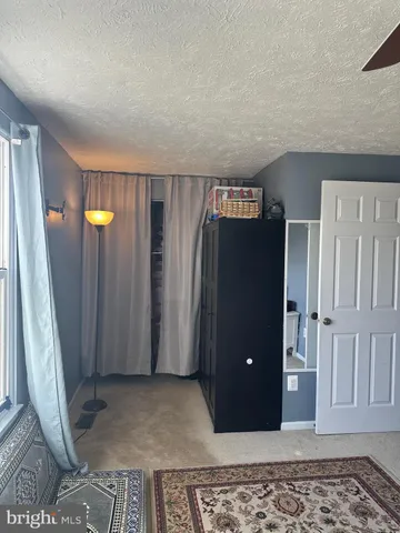 a bedroom with bed and a window