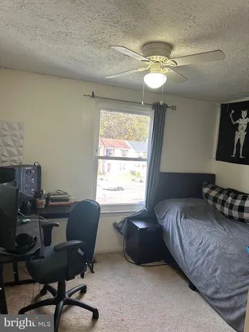 a bedroom with a bed window and cabinet