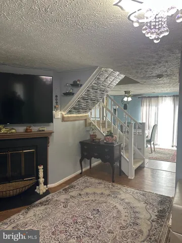 a view of a livingroom with furniture and staircase