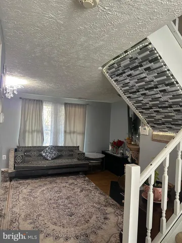 a living room with a couch and a rug