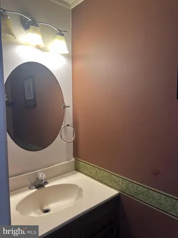 a bathroom with a sink and mirror