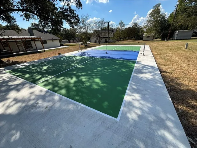a view of backyard with swimming pool