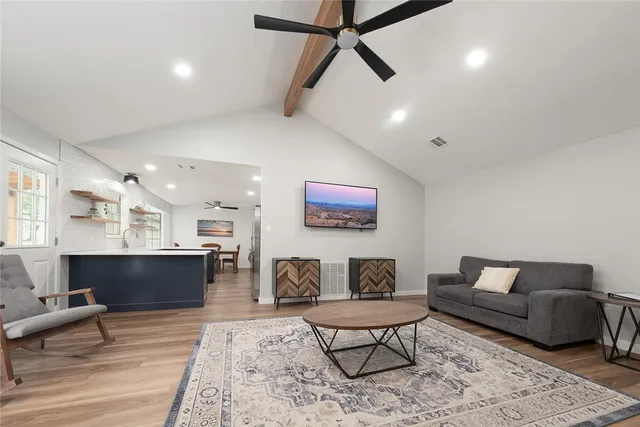 a living room with furniture and a wooden floor