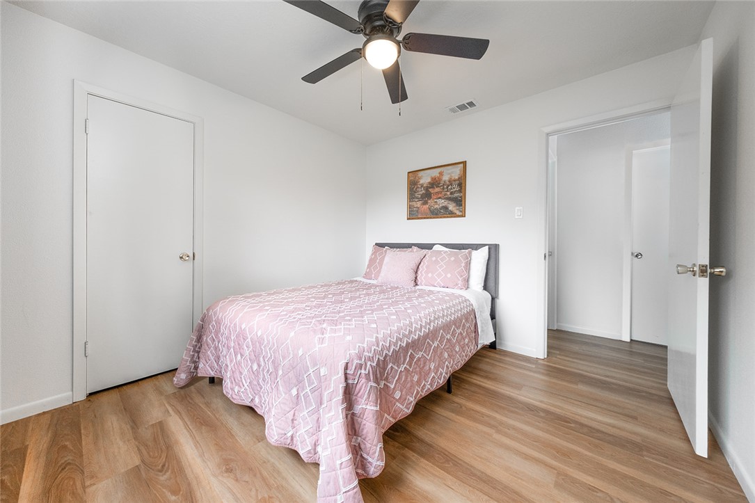 2004 Pinewood Drive Bryan, TX 77807 - Photo 9 of 12 a bedroom with bed and a chandelier