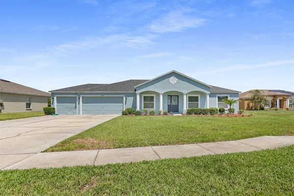 a front view of a house with a yard and garage