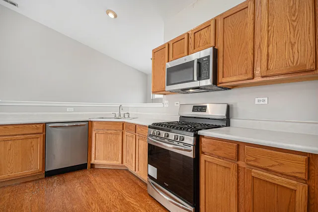 a kitchen with stainless steel appliances granite countertop a stove microwave sink and cabinets