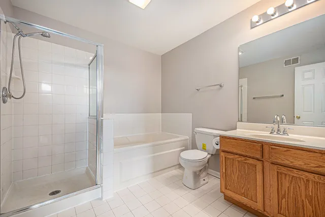 a bathroom with a sink toilet a mirror and shower
