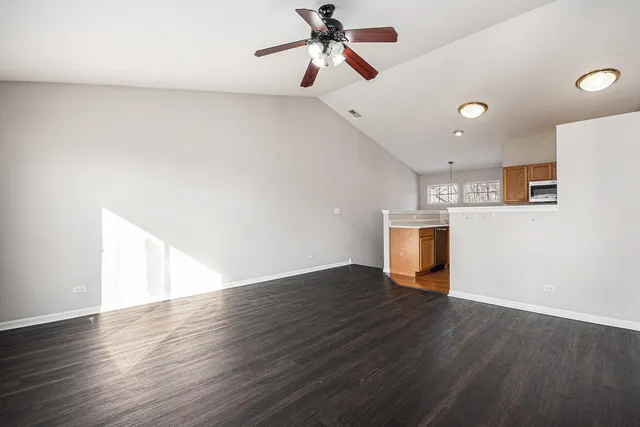 a view of empty room with wooden floor