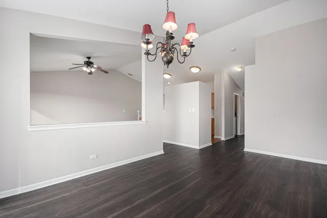 a view of a room with wooden floor