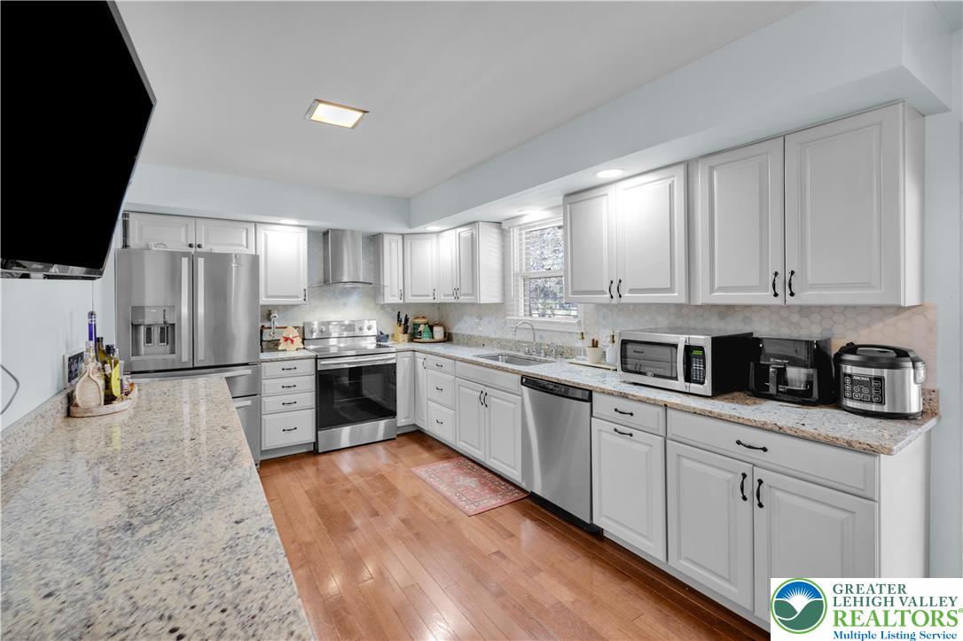 501 Creek Road Bath, PA 18014 - Photo 11 of 50 a kitchen with white cabinets and appliances
